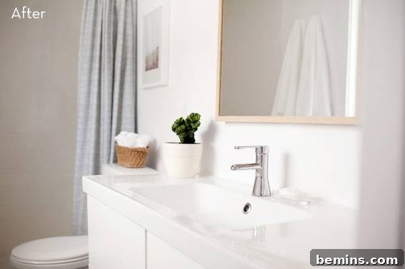 Scandinavian Sanctuary: Bedroom and Bath Transformation 20 A toilet is sitting on the other side of a sink in a bathroom, showing the efficient use of space.