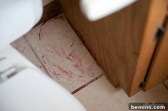 Scandinavian Sanctuary: Bedroom and Bath Transformation 5 Bathroom floor showing signs of damage with red stains.