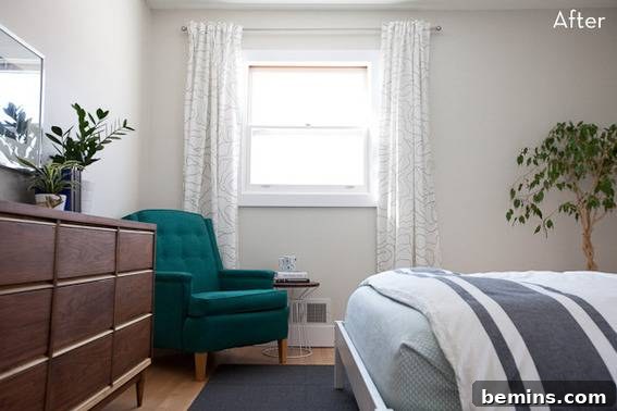 Scandinavian Sanctuary: Bedroom and Bath Transformation 10 A green chair placed near a window in the bedroom, complemented by a brown dresser.