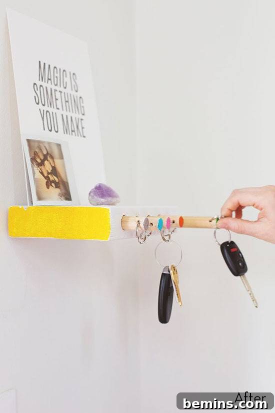 DIY Wooden Key Rack & Shelf: A Pop of Color for Your Entryway 3 Keyholder on the wall with keys hanging and a small picture frame on top.