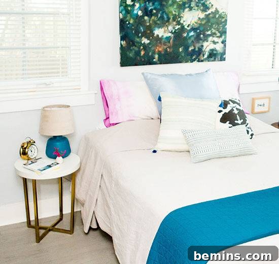 Dip-Dye Pillowcase Perfection: Achieving the Ombre Look with Ease 6 A small table with a blue lamp sitting near a bed.