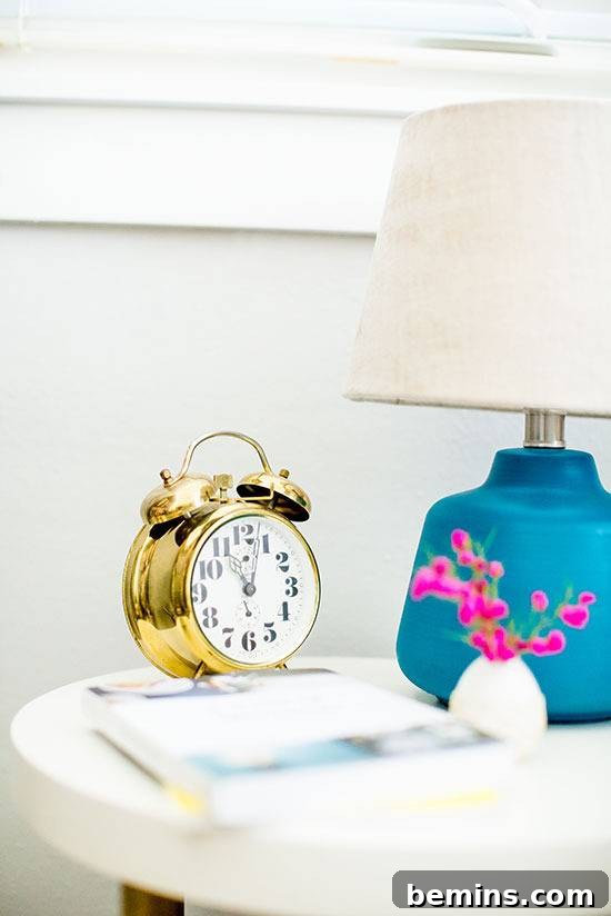 Alarm clock and nightstand is on the white surface table.