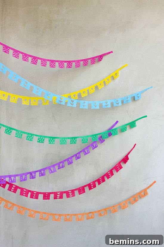 DIY Papel Picado streamers made from intricately cut tissue paper for Cinco de Mayo.