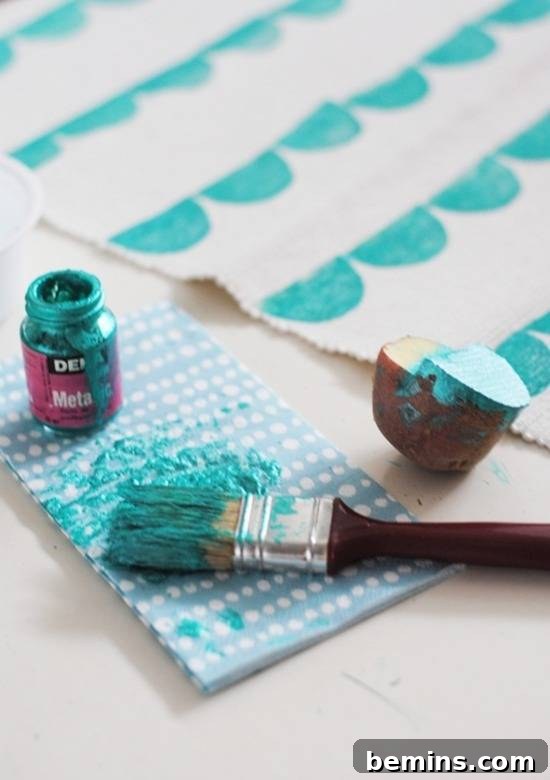 14 Textile DIYs to Level Up Your Craft Game 6 A paintbrush laden with vibrant blue paint being used on white paper, ready to create a stamped design.