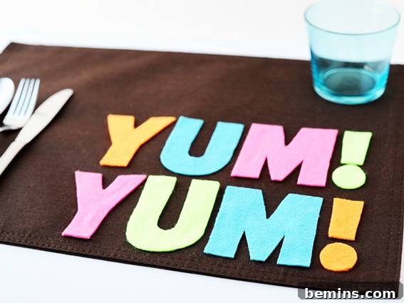 A brown placemat with the words Yum Yum spelled out.