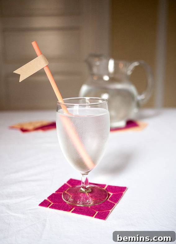 A glass of water on a geometric felt coaster.