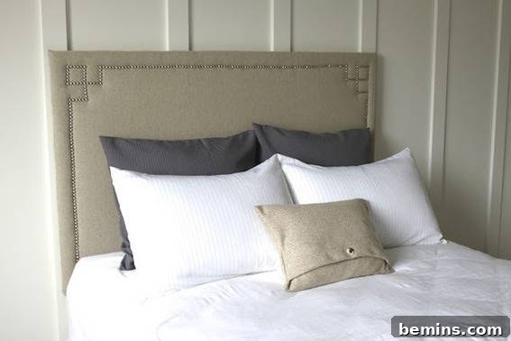 White bed with pewter headboard