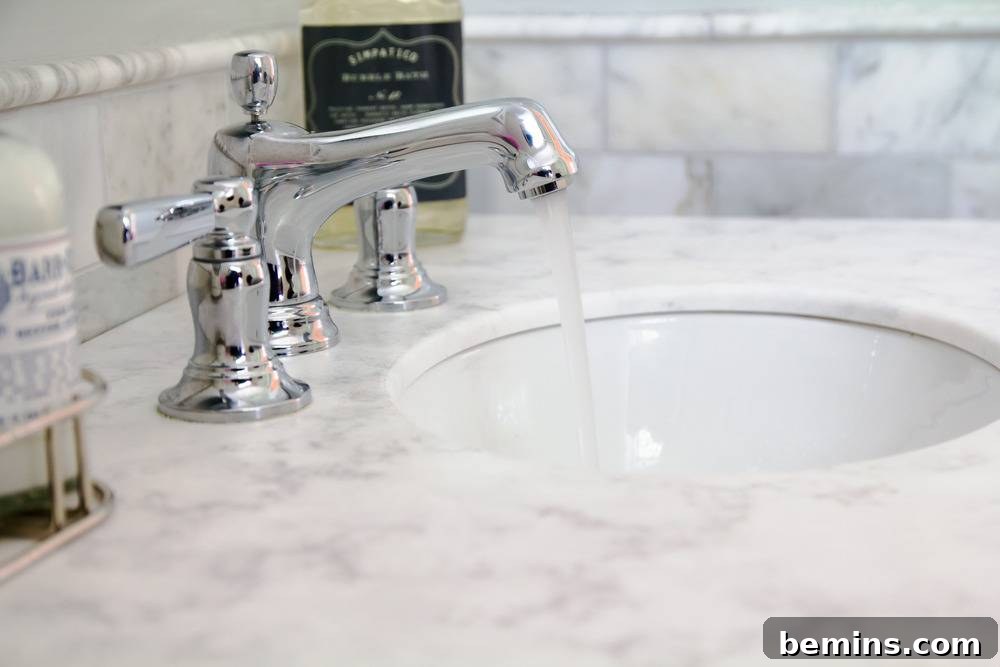 Chrome Kohler Bancroft Fixture with US Marble Aspen Quartz Top and Marble Subway Tile
