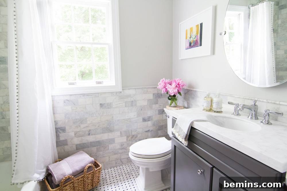 Marble and Chrome Bathroom After Renovation with Grey Vanity