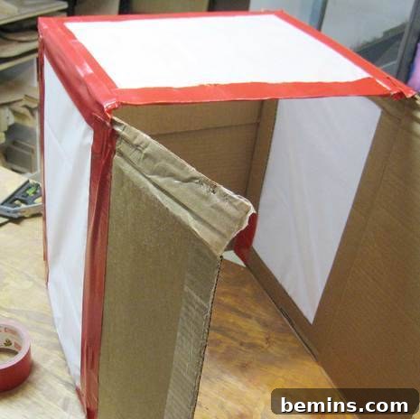 DIY light box with red tape securing the diffusion material.