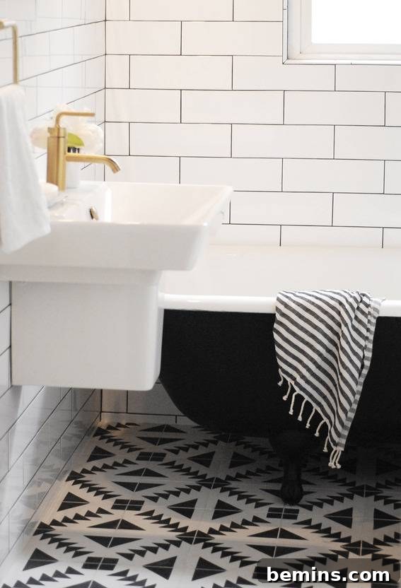 A Harmonious Blend: Black and White Tiles Combine to Create a Striking and Cohesive Restroom Design