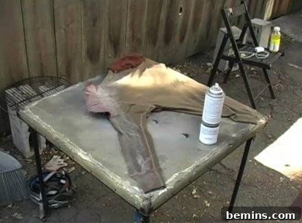 A fabric and glue is placed in a table to prepare superhero costume.