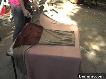 A person is preparing superhero costume in open place.