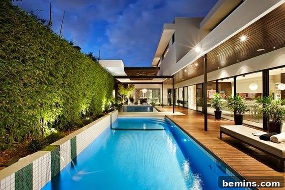 Backyard with swimming pool and lighting