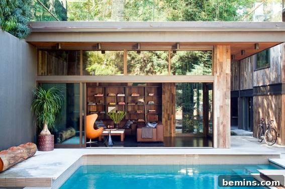 A pool outside of a sitting area of a home.