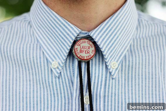 Man posing a button for his collard shirt