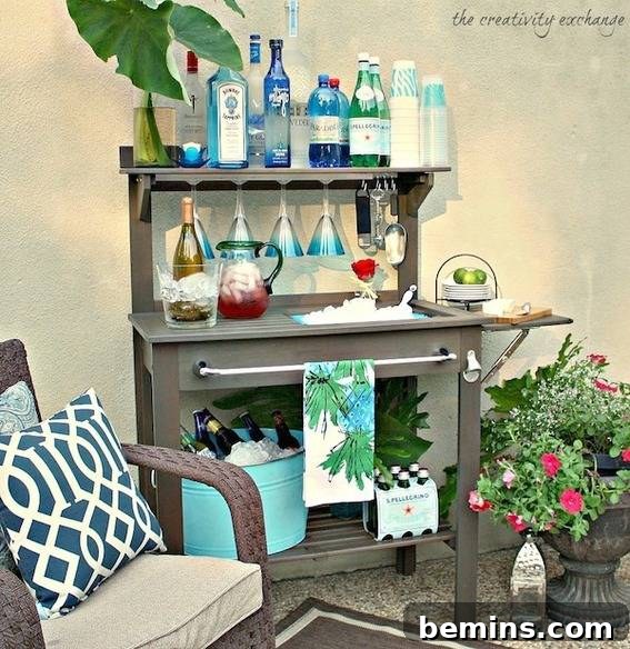 Outdoor Kitchen Dreams: 12 DIY Spaces to Inspire 8 Patio with an armchair and planter next to a gray bar cart holding many bottles.