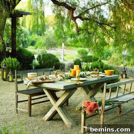 Outdoor Kitchen Dreams: 12 DIY Spaces to Inspire 9 A traditional picnic table with separate bench seats and bright candles sits in a green garden.