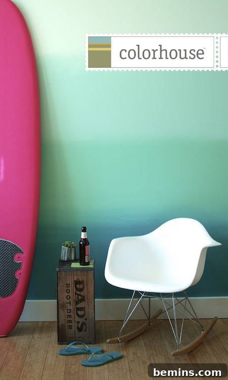 How to Create a Stunning Ombre Wall Effect 3 Modular white chair and magenta surfboard in front of wall pained with blue and aqua ombre effect.