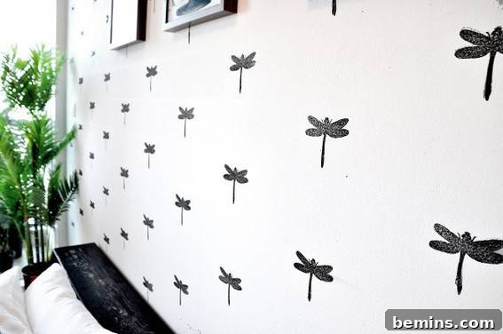 Black and white dragon fly wallpaper in a bedroom.