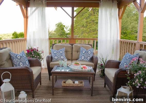 An inviting outdoor space with comfortable sofa cushions and pleasant outdoor curtains creating a relaxing atmosphere.