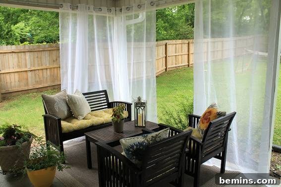 An elegant outdoor sitting area with flowing curtains, creating a serene and inviting space.