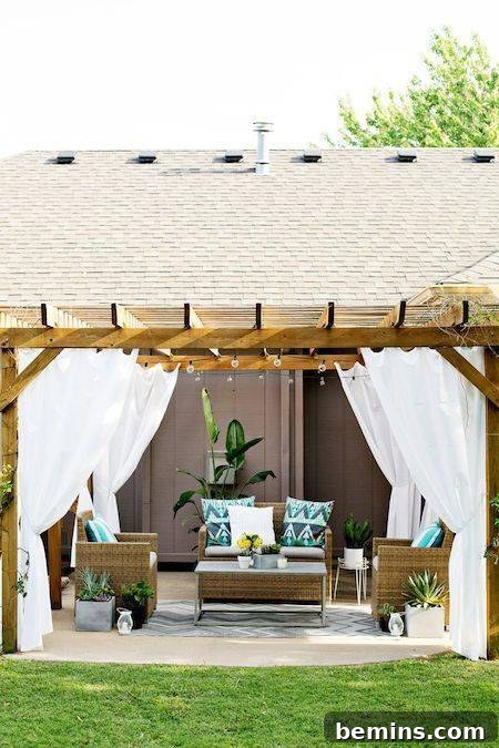Outdoor curtains shielding off the wind in a comfortable and stylish outdoor sitting area.