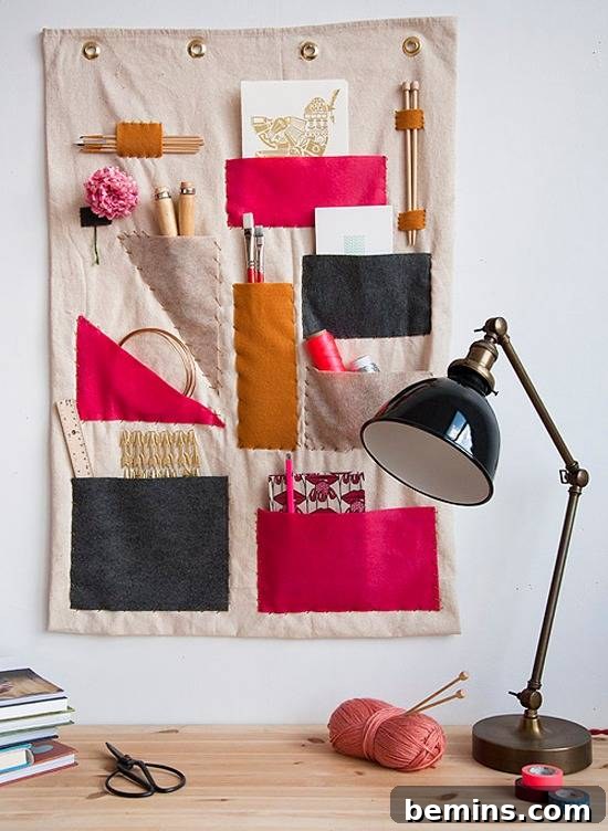 Workspace that has a black desk lamp, and a fabric organizer on the wall.