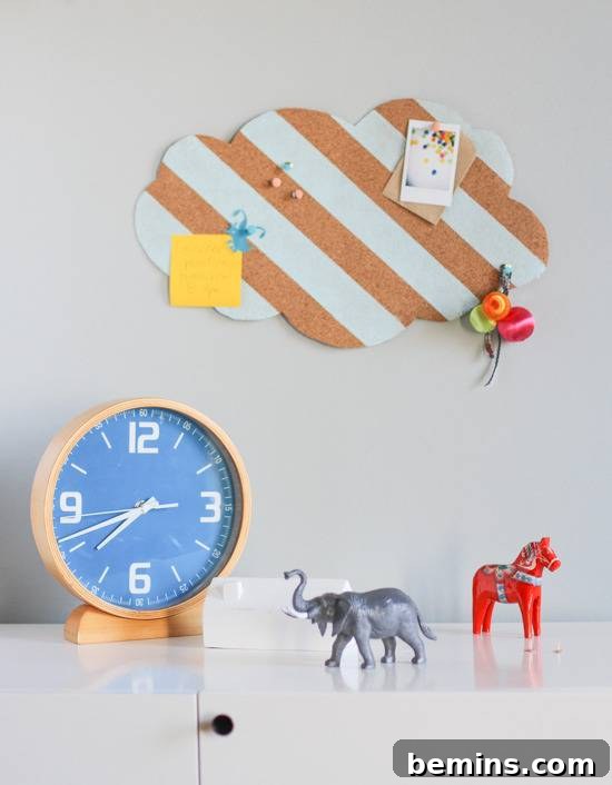 A white desk has animals, a clock and a picture above.