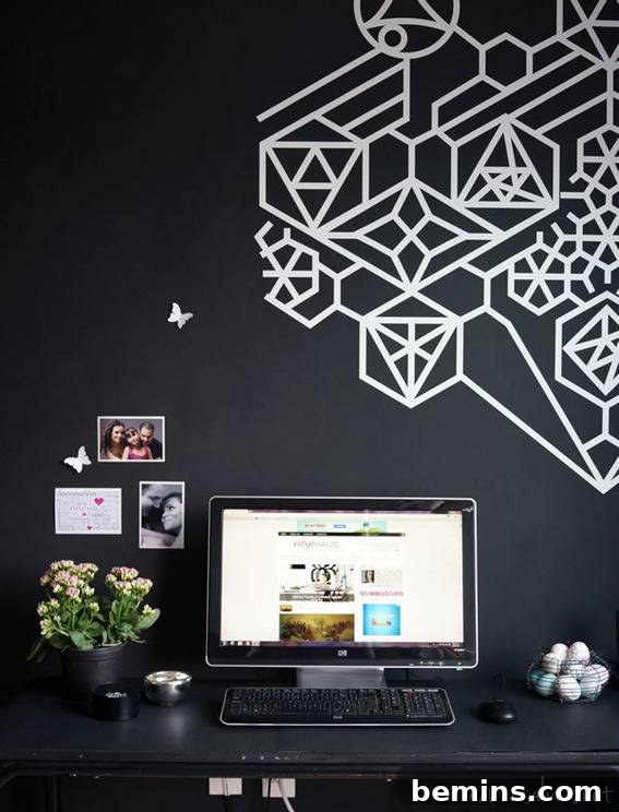 Visually Stunning: 17 Inspiring Workspace Designs 15 A black wall with som ewhite designs, a computer on a desk in between a bowl of golf balls and a white plant.