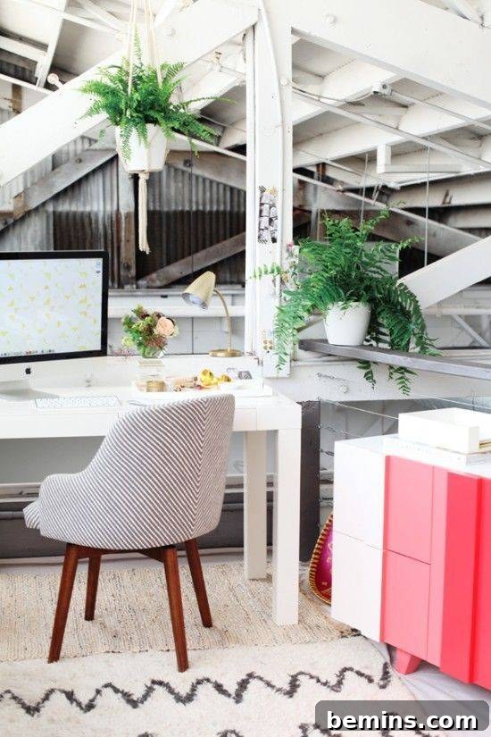 Visually Stunning: 17 Inspiring Workspace Designs 19 A red, pink and white cabinet in a home office with a white table and two ferns.