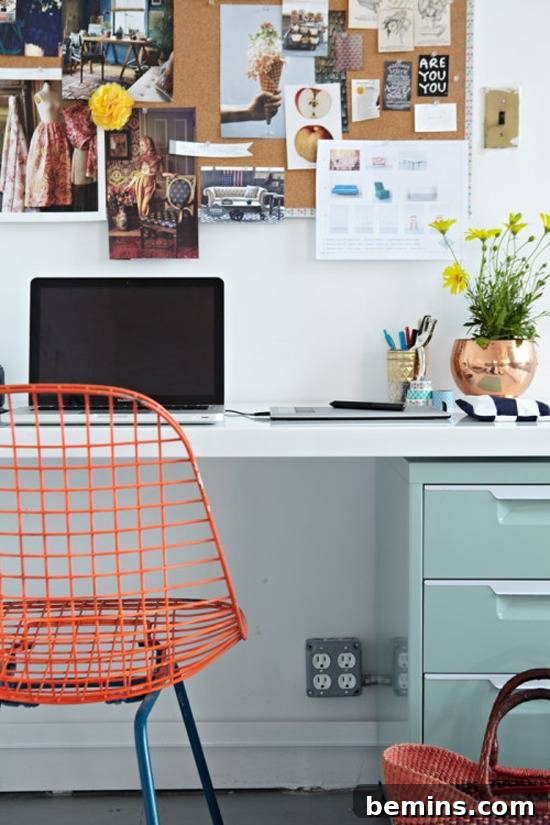 Visually Stunning: 17 Inspiring Workspace Designs 3 A workspace in an office with a blue filing cabinet and an orange chair and pictures on the wall.