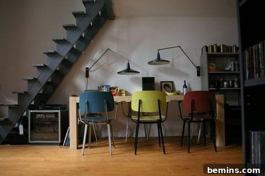 Visually Stunning: 17 Inspiring Workspace Designs 8 A contemporary room has colorful chairs and loft steps.