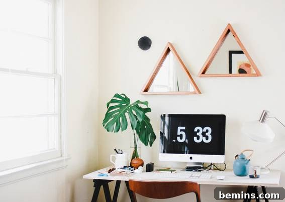 Visually Stunning: 17 Inspiring Workspace Designs 9 A white table has a clock, plants and several household items on top.