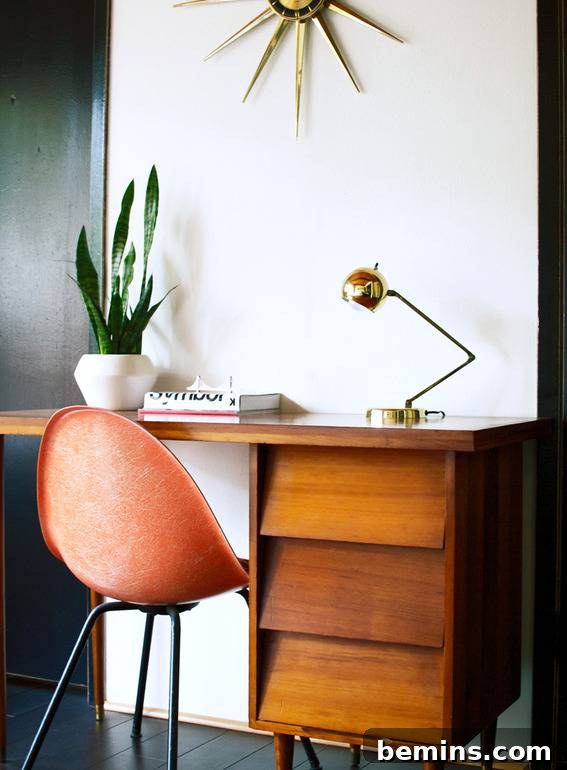 Visually Stunning: 17 Inspiring Workspace Designs 10 A plastic orange 50's style chair sits at an antique wood desk.