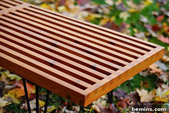 Stylish Seating: 12 DIY Stool and Bench Projects 7 A wooden bench sits outside in the leafy grass.