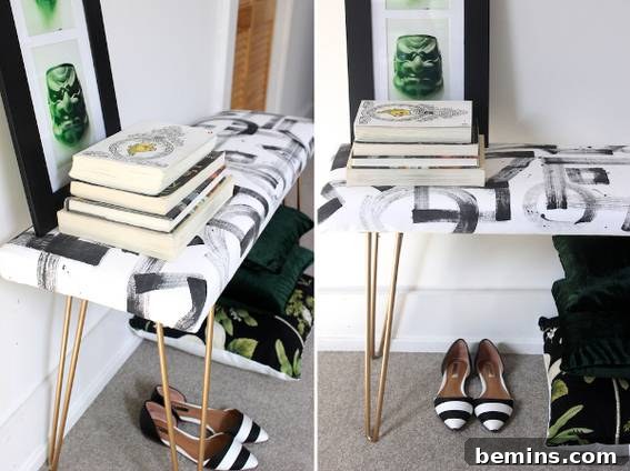 A stack of books on a table with a picture behind it.