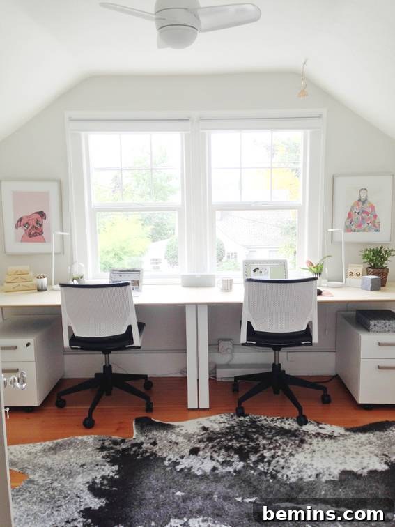 Two chairs sit near desks in a room near a window.