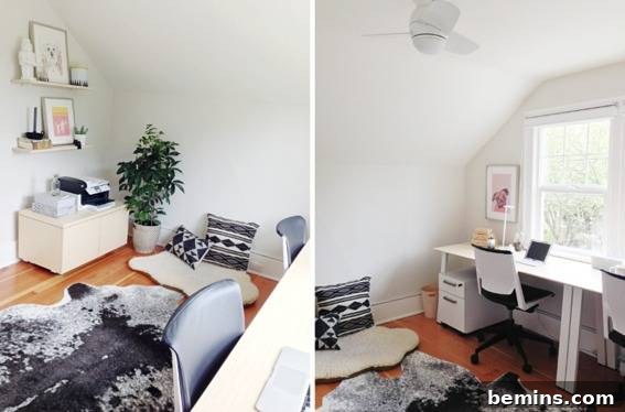 A desk is sitting near a window in a room with white walls.