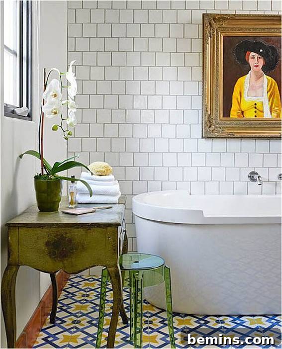 Eye-Catching Floors: 14 Stylish Bathrooms with Patterned Tile 14 White bathroom with a tub under a portrait and patterned floor tiles