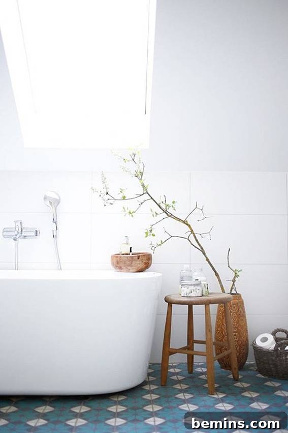 Eye-Catching Floors: 14 Stylish Bathrooms with Patterned Tile 7 Clean white bathroom with blue patterned floor tiles and wooden stool