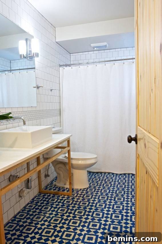 Eye-Catching Floors: 14 Stylish Bathrooms with Patterned Tile 9 Modern bathroom with toilet, mirror, and patterned floor tiles