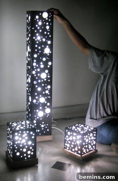 Person displaying unique lamps with bright stars on a black background.