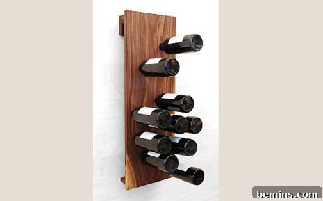 Wine bottles displayed stem-first in a wall-mounted wooden panel.
