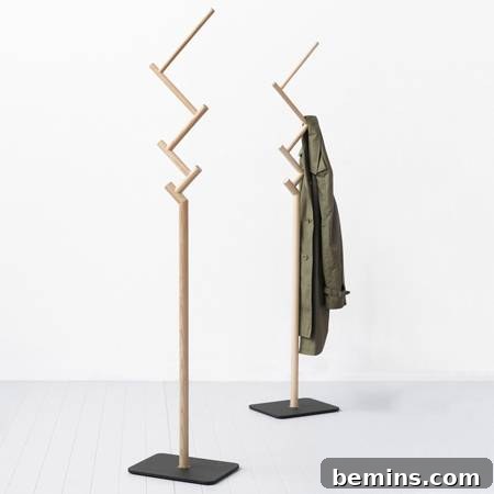 Coat hanging on a rustic DIY twig coat rack.