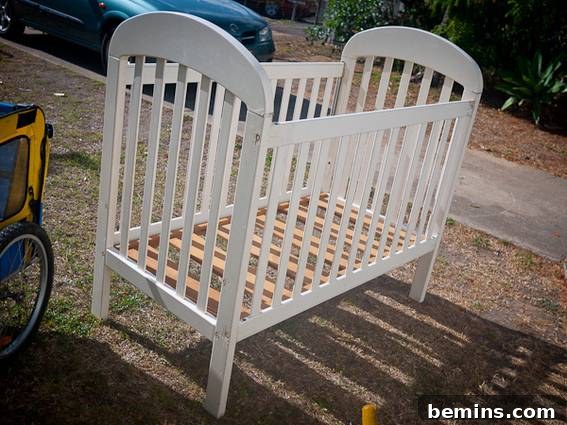 A white wooden crib sits outside.