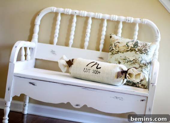An old bench has been repurposed into a new piece of functional furniture, displayed with two throw pillows on it.