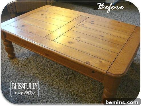 A big, and short country wooden table sits in a carpeted room.