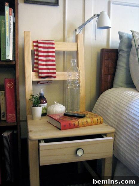 A brown chair with a red and white towel, a book, and a few random objects on it with a drawer under the seat.