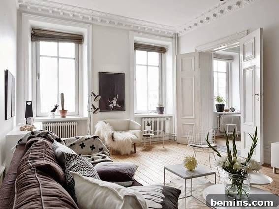 A bright and airy living room with white walls and a large, comfortable sofa.